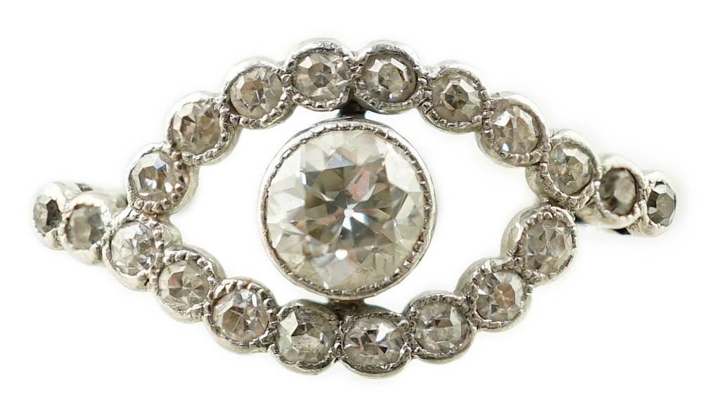 A white metal and single stone elliptical shaped ring, with diamond set border and shoulders, size M, gross weight 2.1 grams.